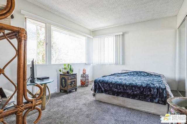 carpeted bedroom featuring a textured ceiling