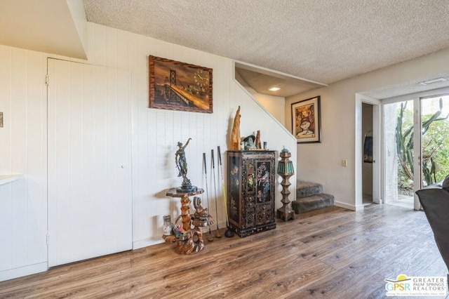 interior space featuring hardwood / wood-style flooring and a textured ceiling