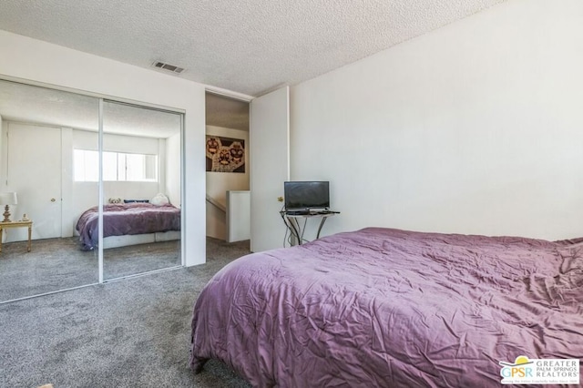 carpeted bedroom featuring a closet and a textured ceiling