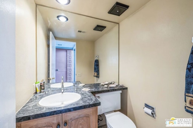 bathroom with vanity and toilet