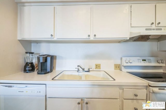 kitchen with white cabinetry, sink, and white appliances