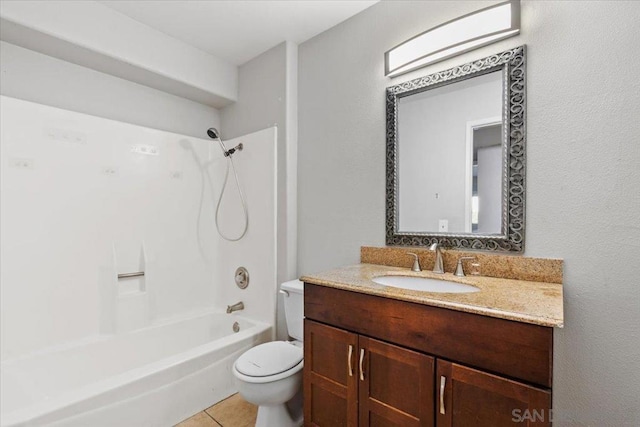 full bathroom with washtub / shower combination, vanity, toilet, and tile patterned floors