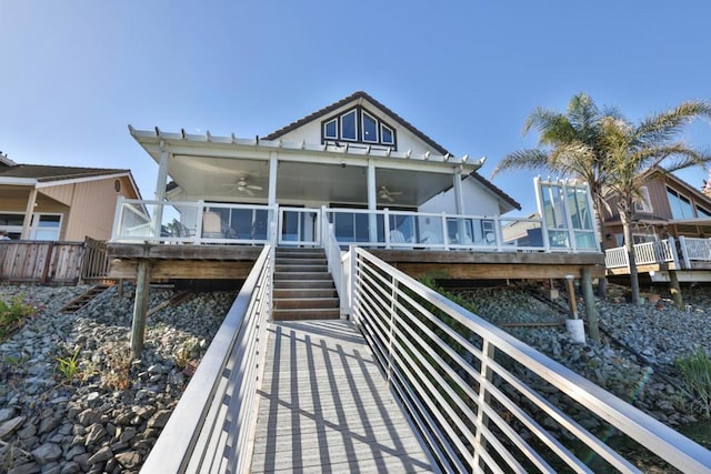 rear view of house featuring ceiling fan