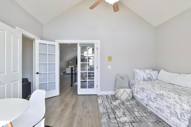 bedroom with french doors, ceiling fan, vaulted ceiling, and light wood-type flooring