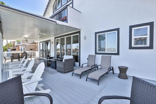 deck with ceiling fan and an outdoor living space