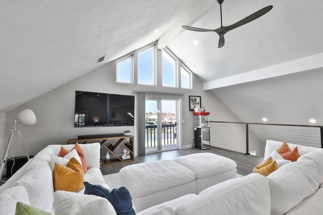 living room with lofted ceiling with beams, ceiling fan, a textured ceiling, and dark hardwood / wood-style flooring