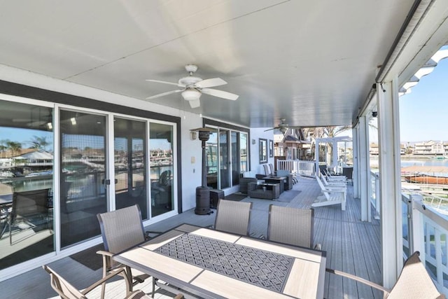 exterior space featuring ceiling fan and a water view