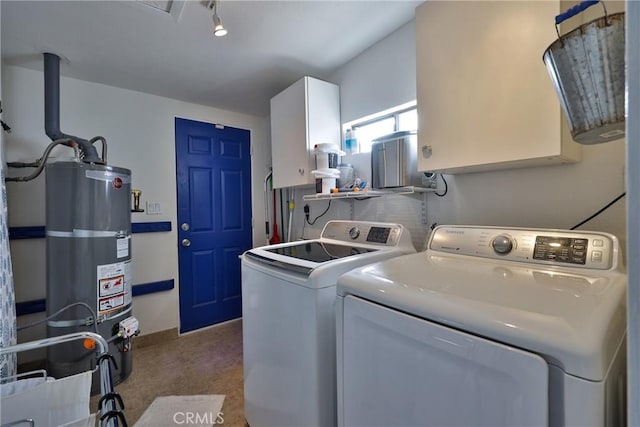 clothes washing area featuring independent washer and dryer, cabinets, and secured water heater