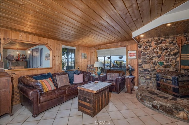 tiled living room featuring wood ceiling and wood walls