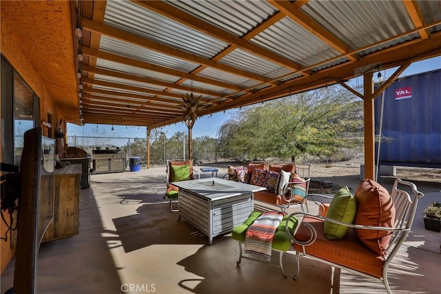 view of patio / terrace featuring area for grilling and a fire pit