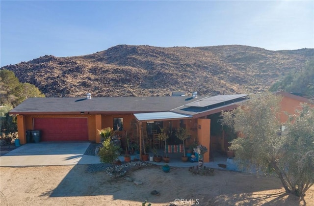 view of front facade featuring a mountain view and a garage