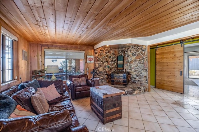 living room with light tile patterned flooring, a barn door, a healthy amount of sunlight, and wood ceiling