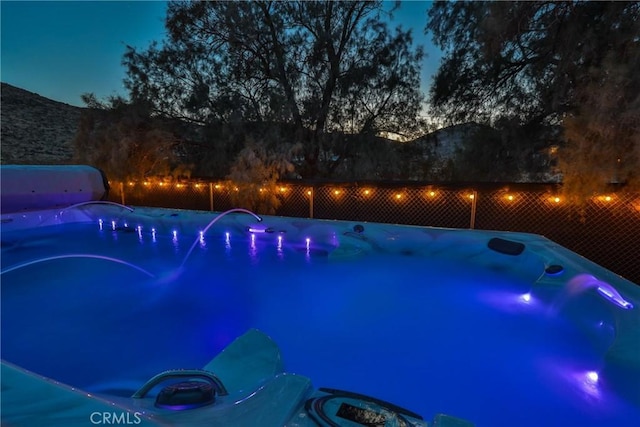 view of pool at dusk