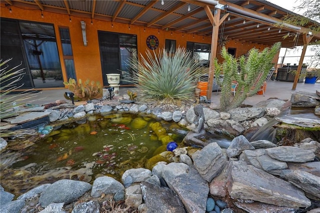 exterior space featuring a garden pond