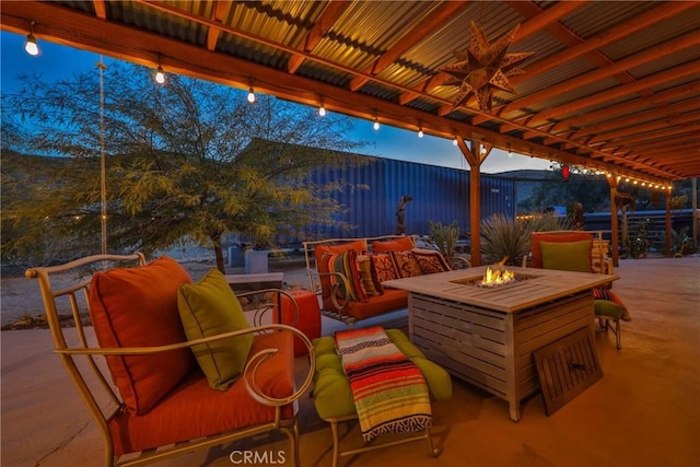 patio terrace at dusk featuring an outdoor living space with a fire pit