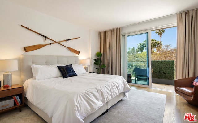 bedroom with access to outside and light hardwood / wood-style floors