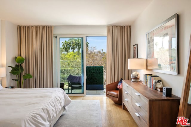 bedroom with light hardwood / wood-style flooring and access to outside