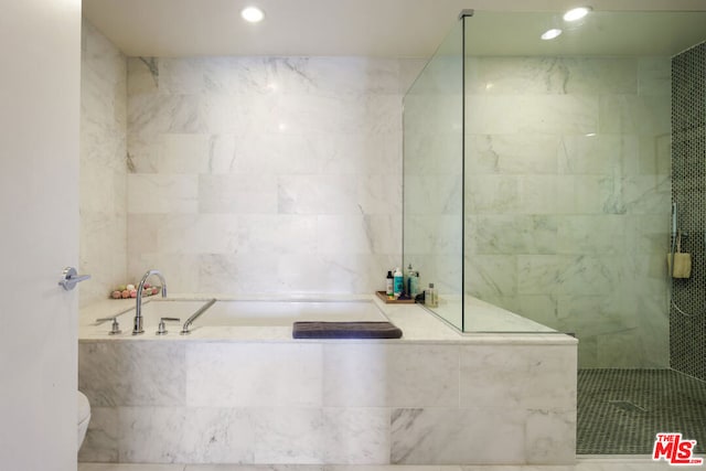 bathroom with independent shower and bath and tile walls