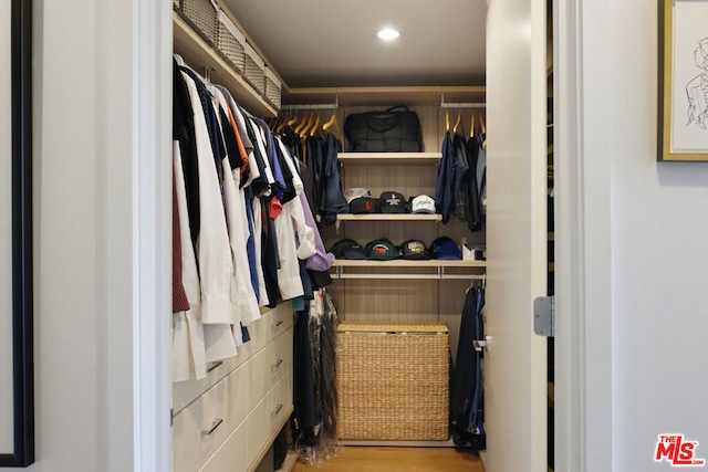 walk in closet with light wood-type flooring