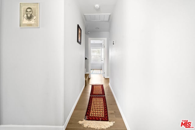 corridor featuring wood-type flooring