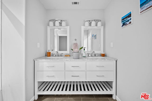 bathroom with tile patterned floors and vanity