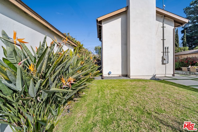 view of side of home featuring a yard