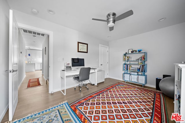 office space featuring ceiling fan and hardwood / wood-style floors