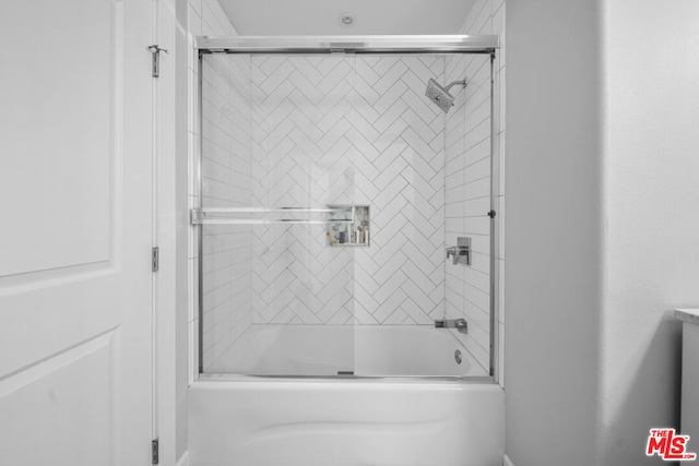 bathroom featuring shower / bath combination with glass door