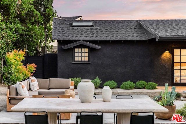 patio terrace at dusk with an outdoor hangout area