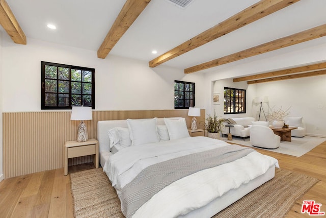 bedroom featuring beam ceiling and wood-type flooring