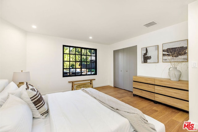 bedroom with a closet and light wood-type flooring