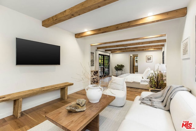 living room featuring beam ceiling and hardwood / wood-style floors