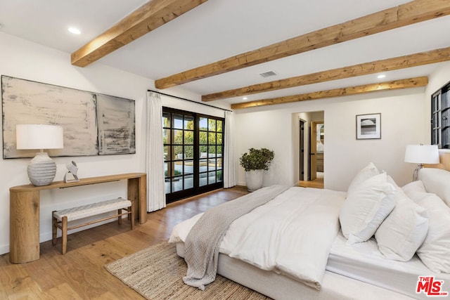 bedroom featuring hardwood / wood-style flooring, access to outside, french doors, and beamed ceiling