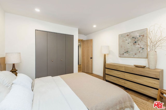 bedroom featuring a closet and light hardwood / wood-style flooring