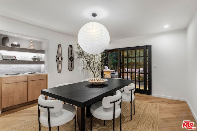 dining space with light wood-type flooring