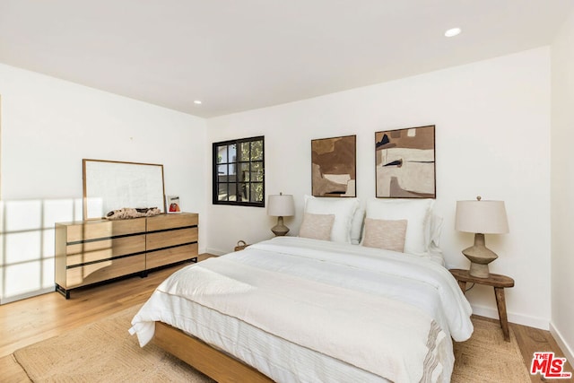 bedroom with hardwood / wood-style flooring