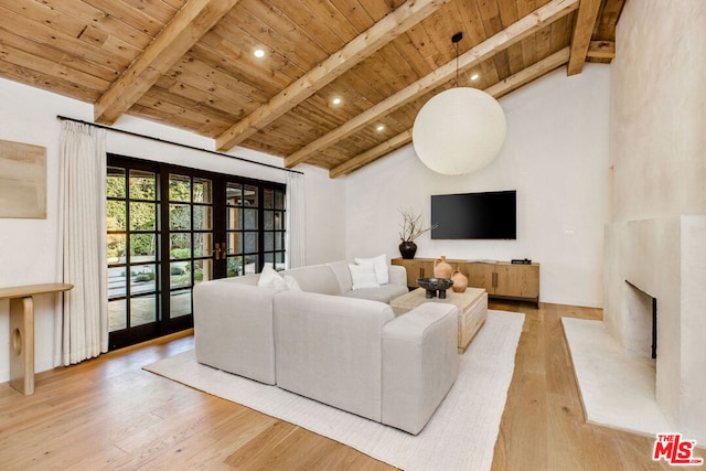 living room featuring a fireplace, beamed ceiling, french doors, wooden ceiling, and light hardwood / wood-style flooring