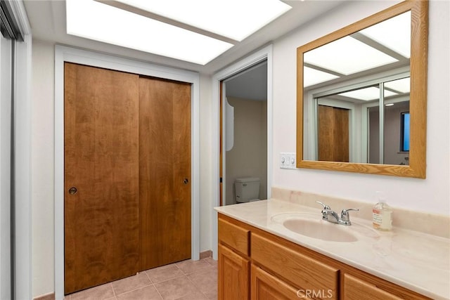 bathroom with vanity, tile patterned floors, and toilet