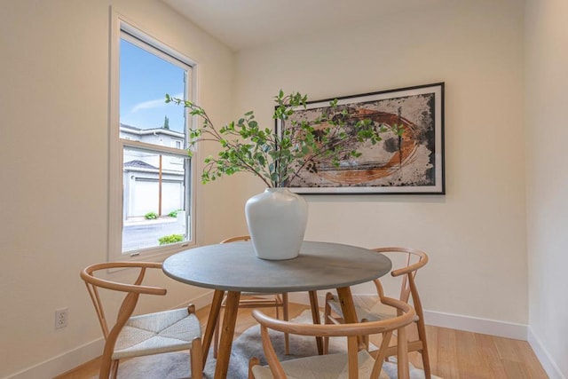 dining area with a wealth of natural light and light hardwood / wood-style floors