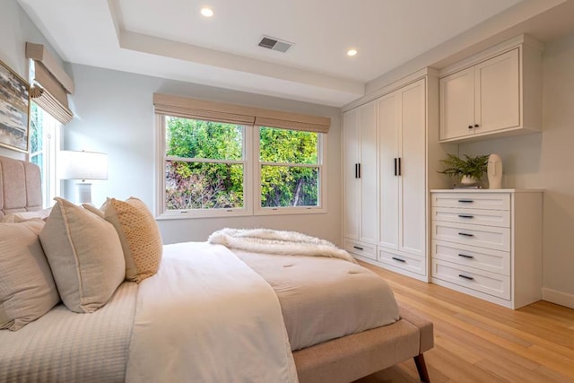 bedroom featuring multiple windows and light wood-type flooring