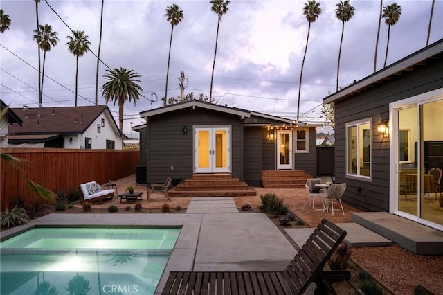 back of house featuring entry steps, a patio area, french doors, and fence