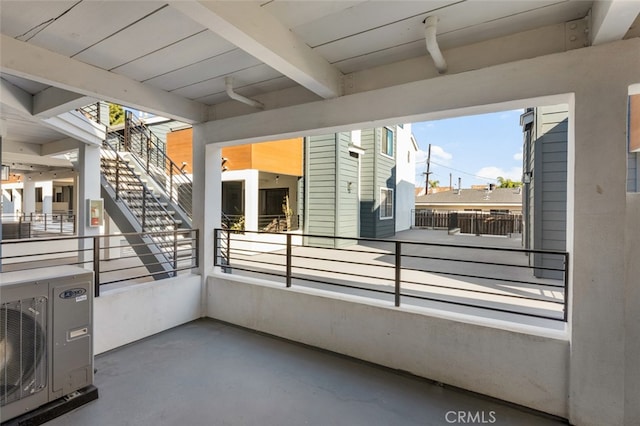 view of patio with a balcony and ac unit