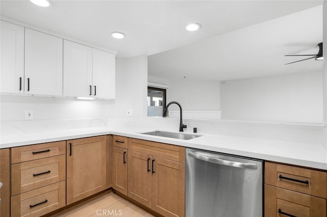 kitchen featuring sink, white cabinetry, light stone counters, stainless steel dishwasher, and ceiling fan