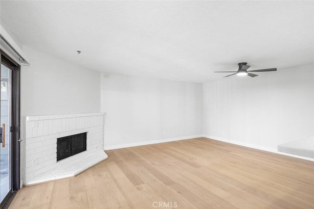 unfurnished living room featuring light hardwood / wood-style flooring, a fireplace, and ceiling fan