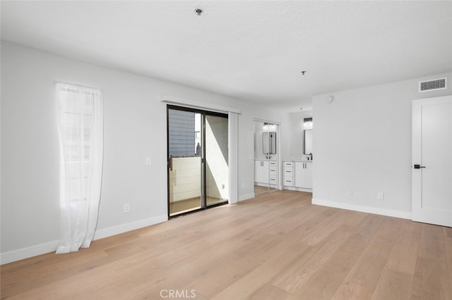 spare room with light wood-type flooring