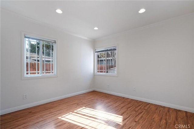 unfurnished room with crown molding and light hardwood / wood-style flooring