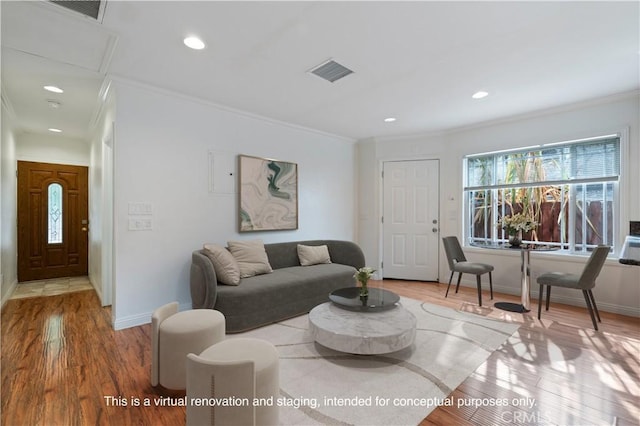 living room with crown molding and light hardwood / wood-style floors