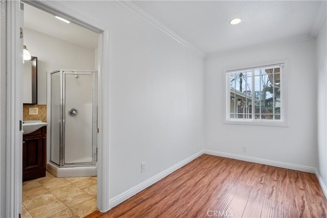 unfurnished room featuring ornamental molding and light hardwood / wood-style floors