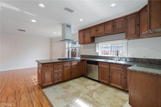 kitchen featuring sink, dark stone counters, island exhaust hood, kitchen peninsula, and stainless steel appliances