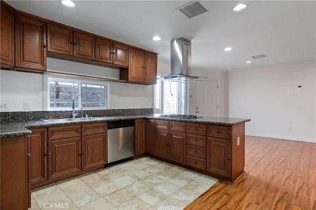 kitchen featuring sink, dark stone countertops, appliances with stainless steel finishes, kitchen peninsula, and island exhaust hood